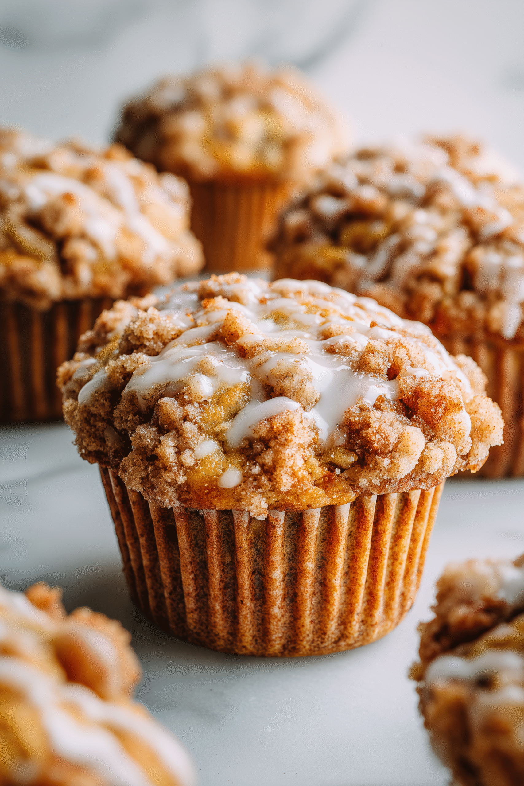 Close-up of Apple Muffins with a streusel topping, showing the moist crumb and apple pieces.