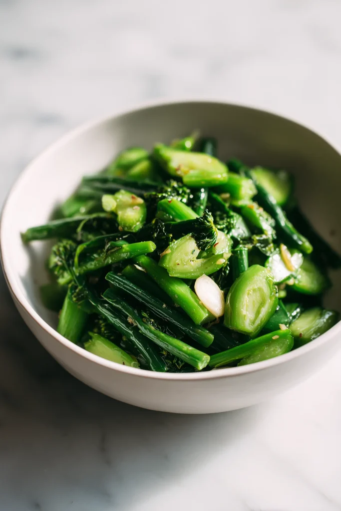 Brussels sprouts tossed with garlic and olive oil in a white bowl, prepared for roasting.
